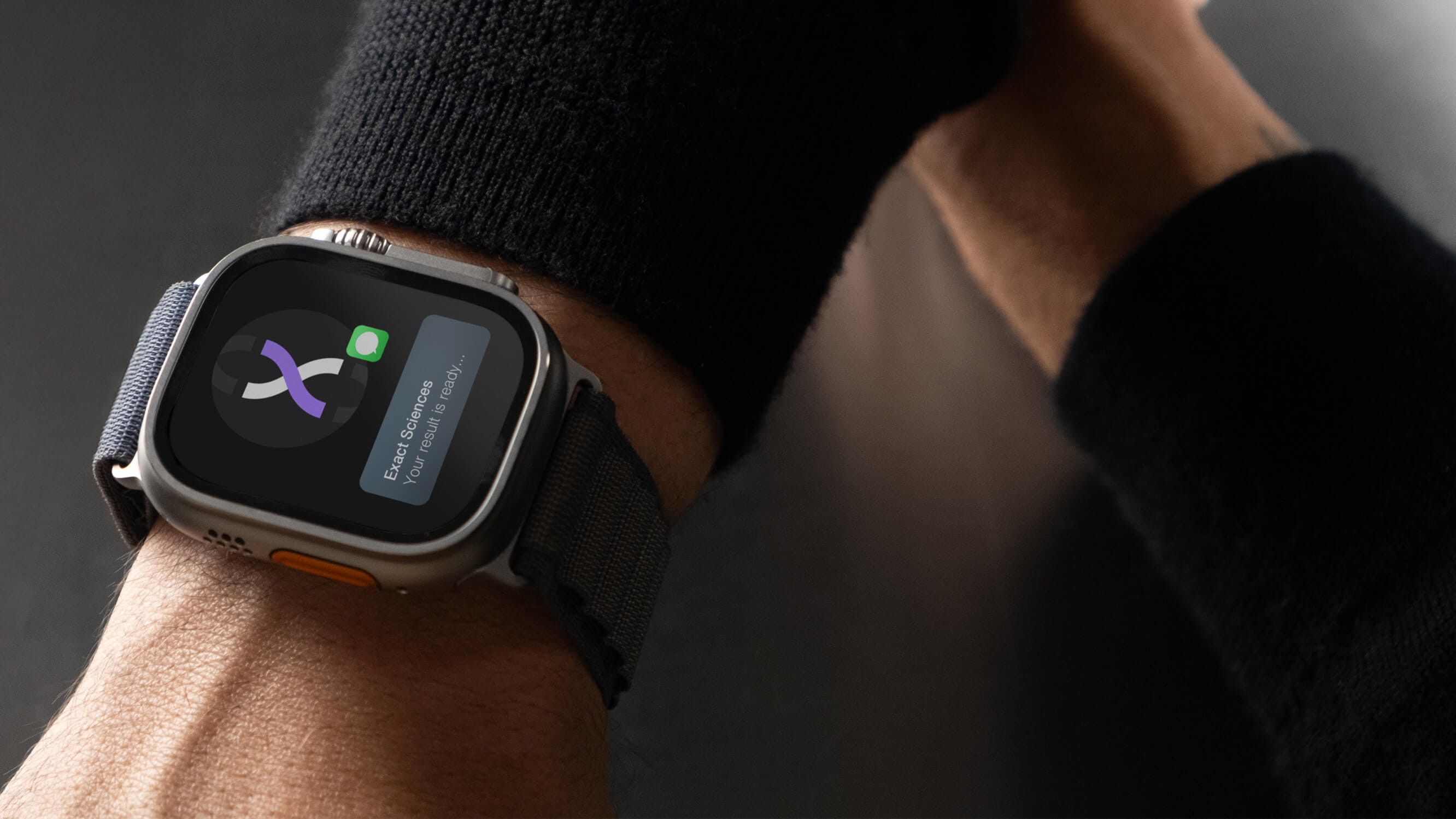 A close up of a man receiving a smartwatch notification that his test results are ready.