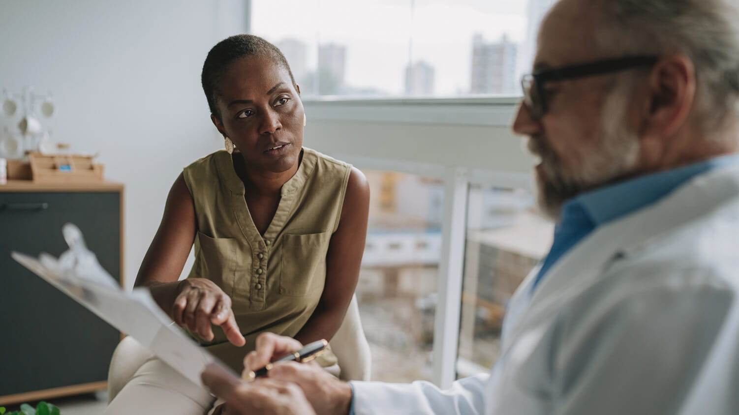 A patient talking to her doctor about her test results.