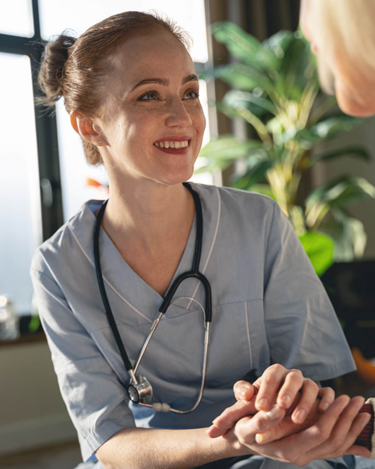 A nurse smiling at a patient.